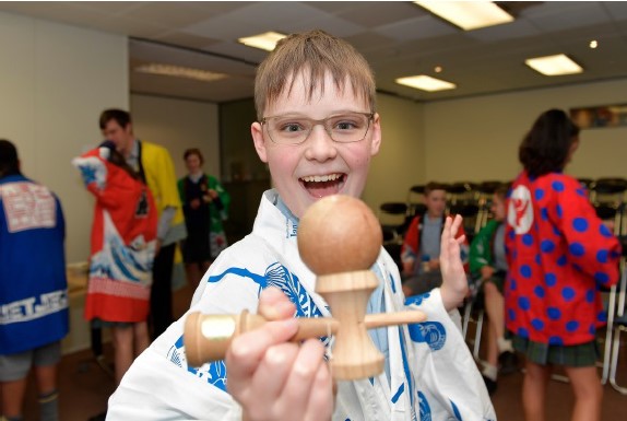 A student shows off his balancing skills with a kendama